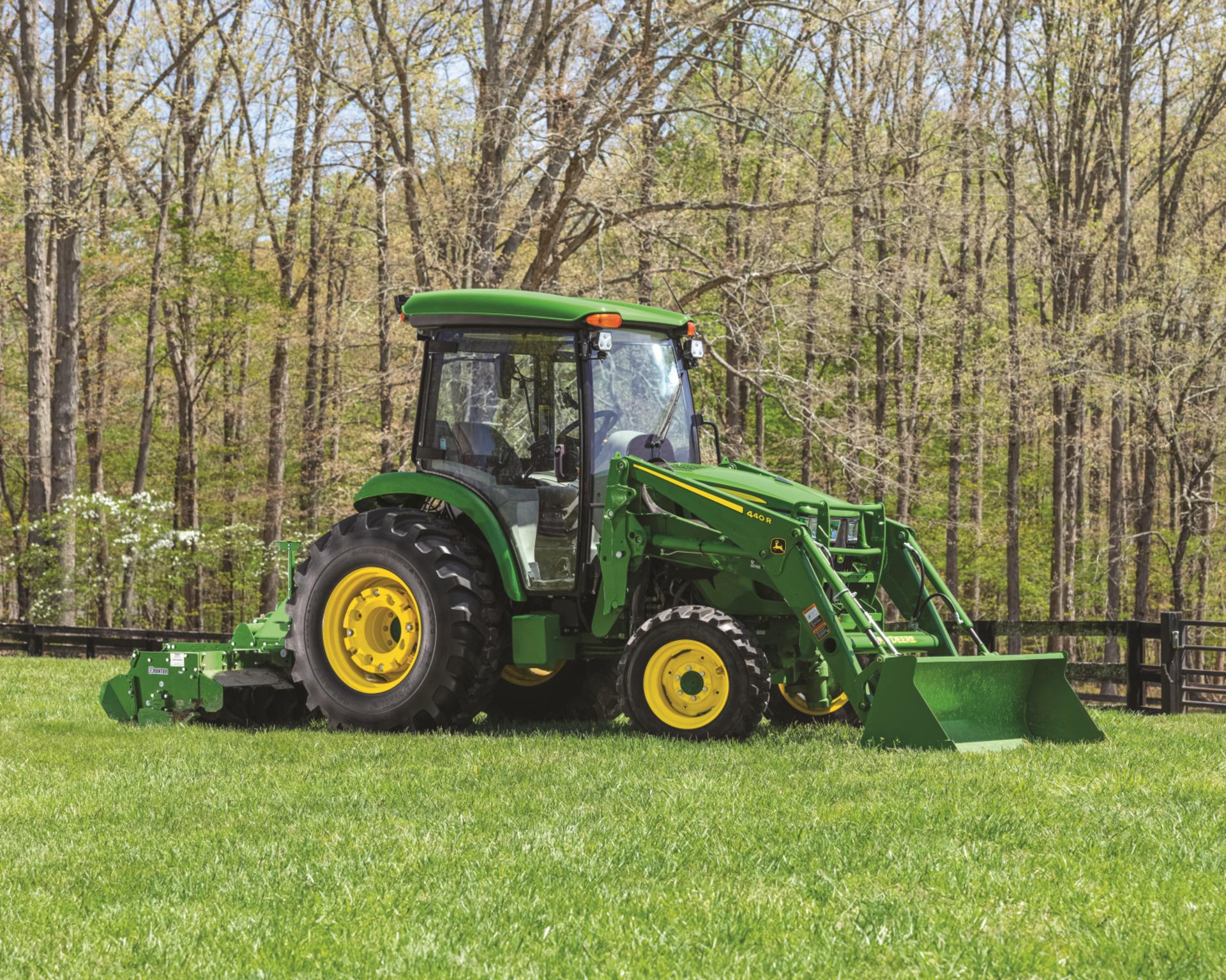 A John Deere 4 Series tractor in a field.