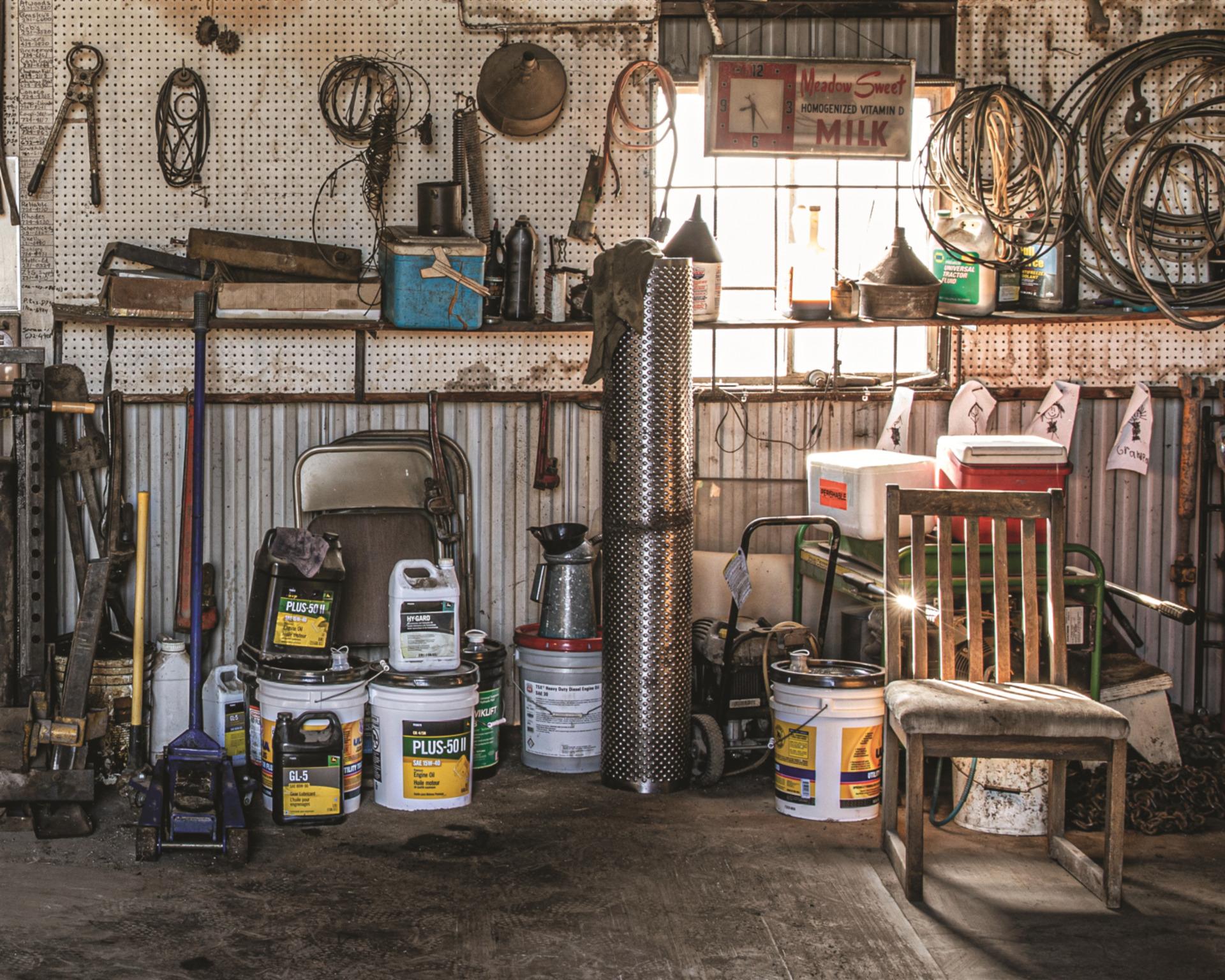Tools in a garage for lawn tractor maintenance and repair.