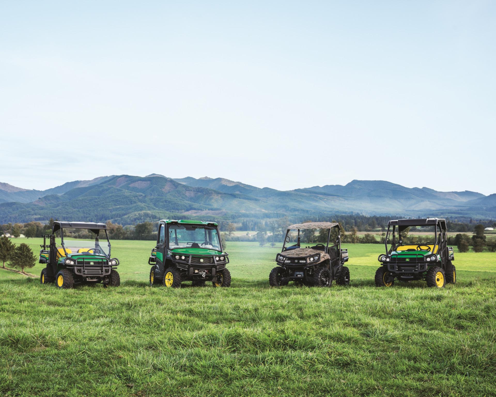 A group shot of Gator UTVs, gas and diesel, in a pasture.