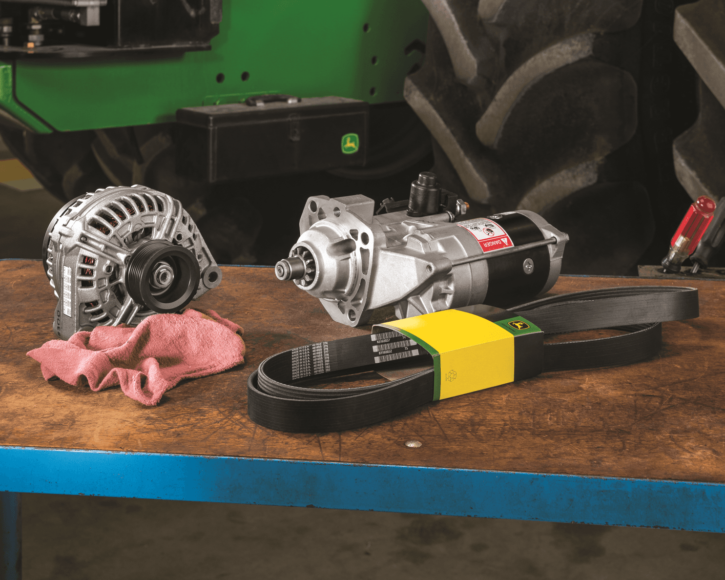 Parts, including a belt, for replacement on a John Deere mower.