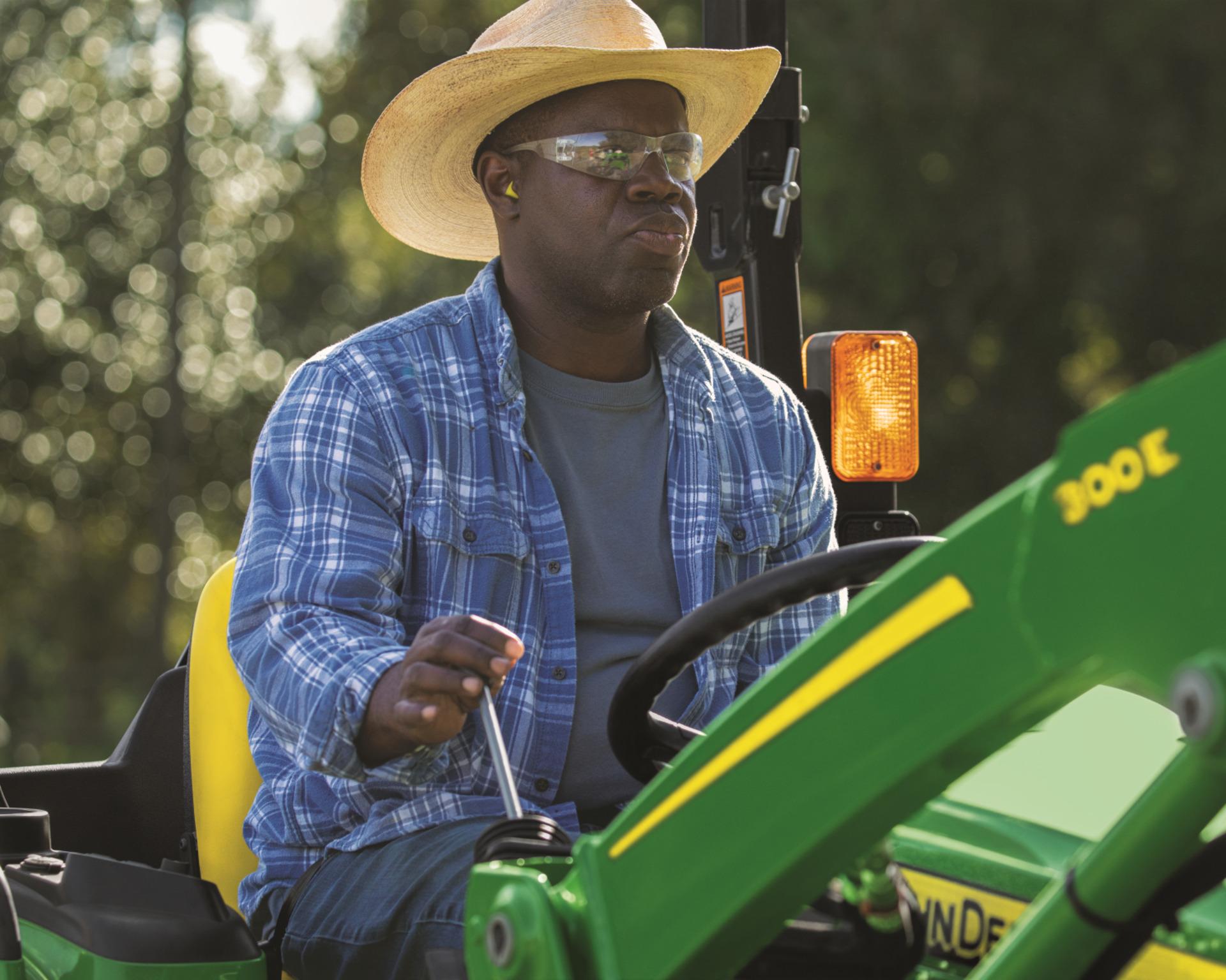 A John Deere 3032E operated by a worker in Tennessee.