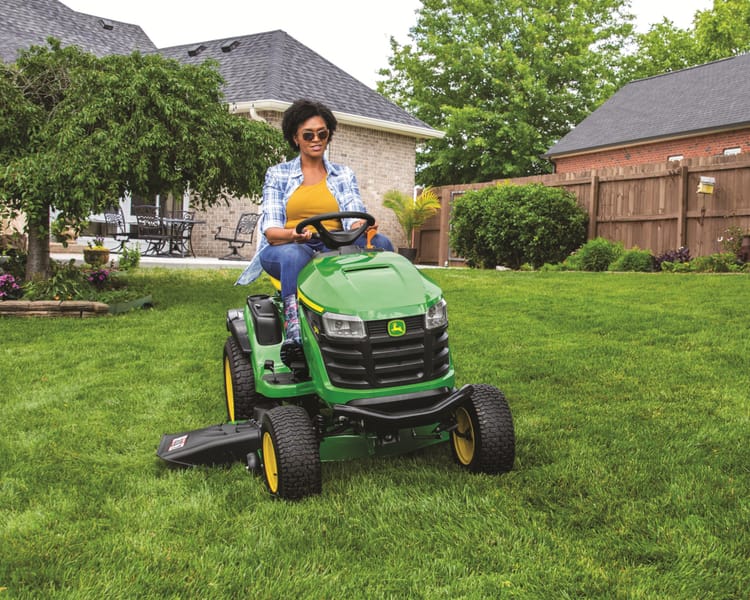 An operator mows their lawn with a S170 Lawn Tractor.