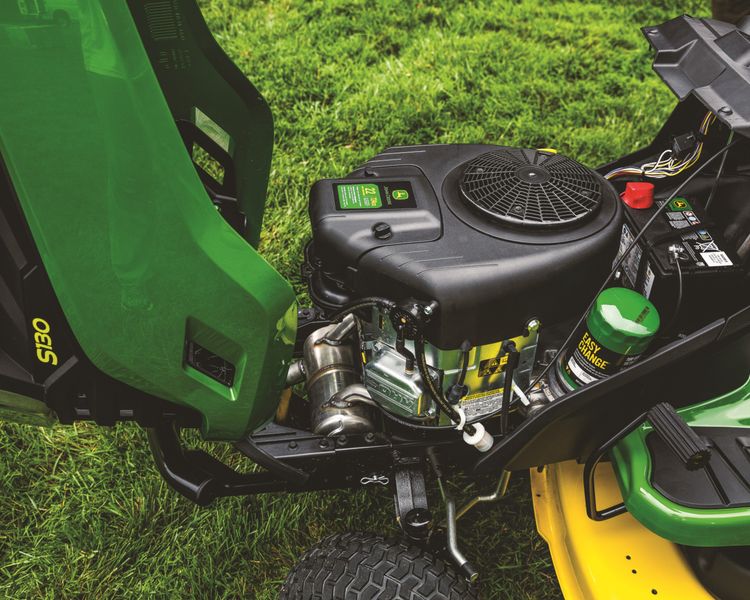A John Deere lawn tractor engine preparing for repair.