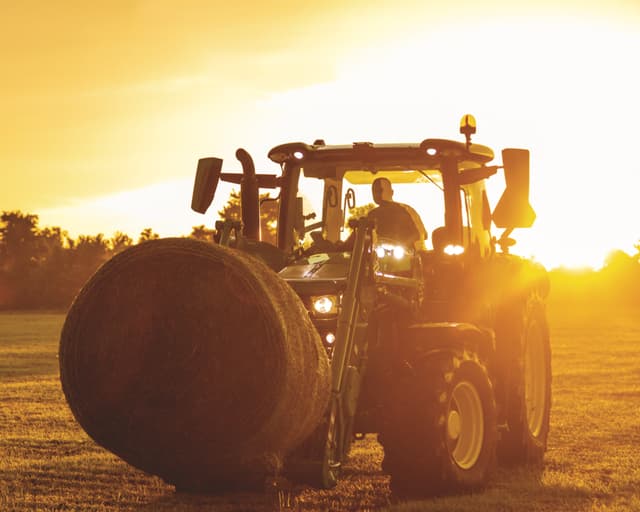 TNTR fall tractor maintenance 1 A tractor with a bale spear attachment moves a hay bale in Tennessee.