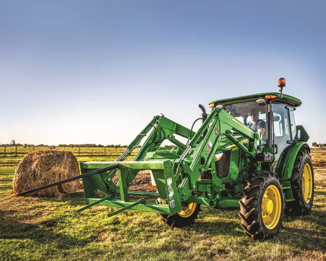 TNTR 5 series 1 A John Deere 5 Series Tractor with a bale spear moves hay.