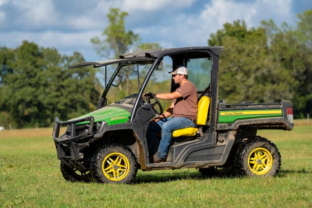 TNTR gator 1 A property owner surveys his cow pasture with a John Deere Gator.