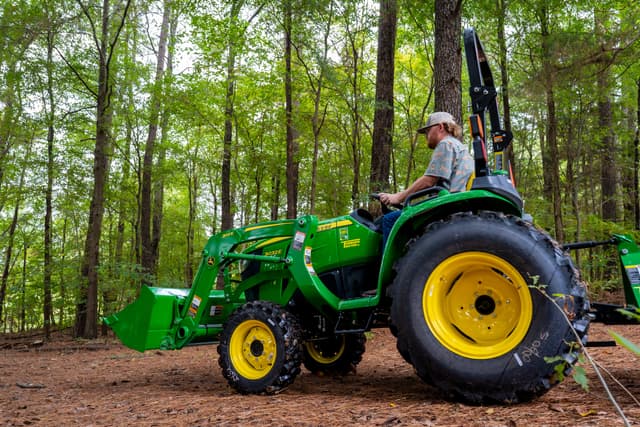 John Deere tractor A property manager uses a John Deere tractor to maintain the land around their creek.