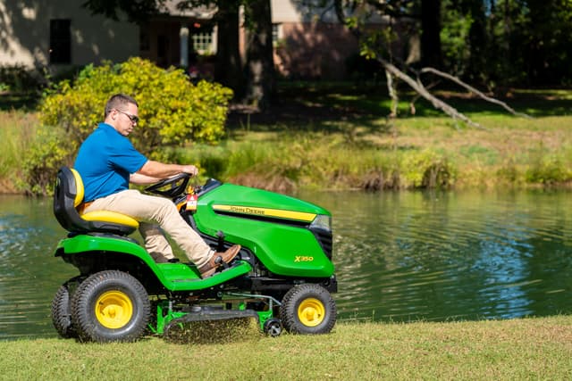 DSC00894 (1) A man operates a John Deere X350 on a lawn in Tennessee.