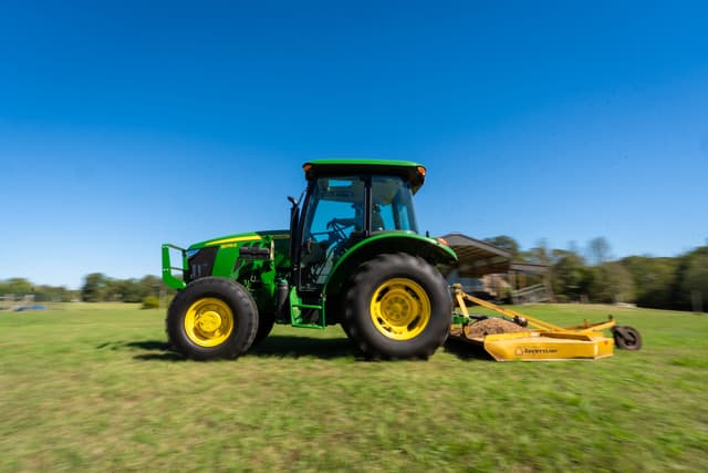 DSC01698 (1) A John Deere tractor with a rotary cutter attachment mows a field in Tennessee.