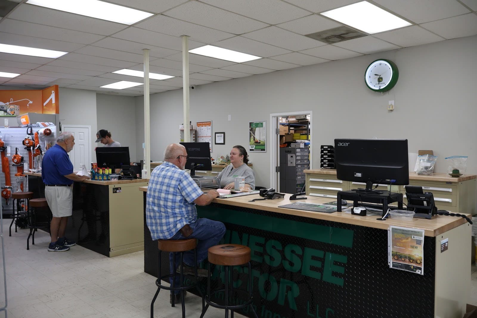 A service counter with customers at a Tennessee Tractor location.