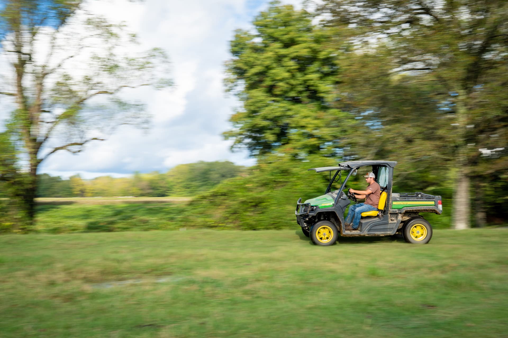 A John Deere Gator moves across a field on a property in Tennessee.